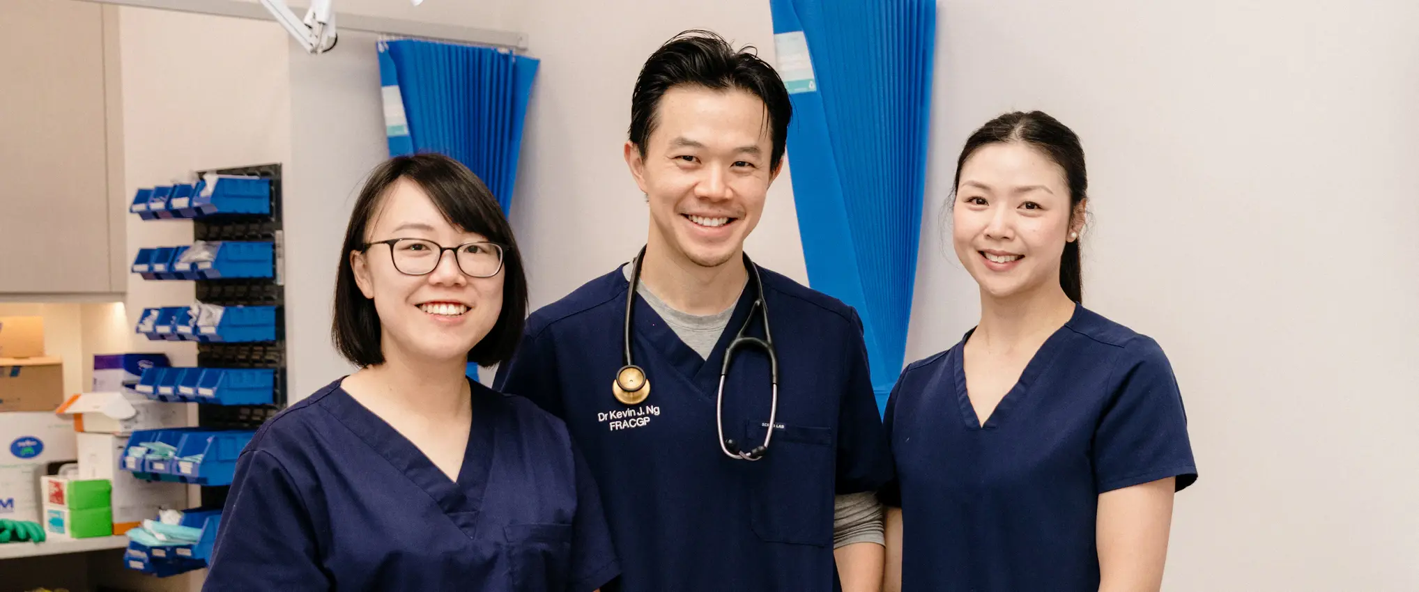 General practitioner and team smiling together in a clinical room (1)